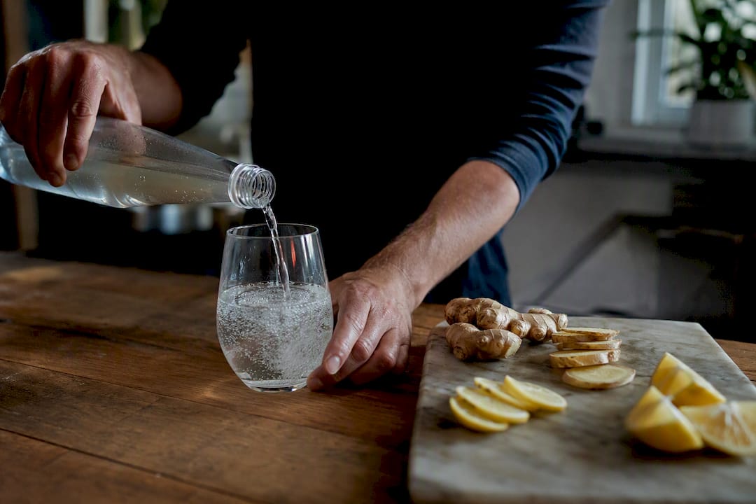 Pouring prebiotic soda into glass with bubbles