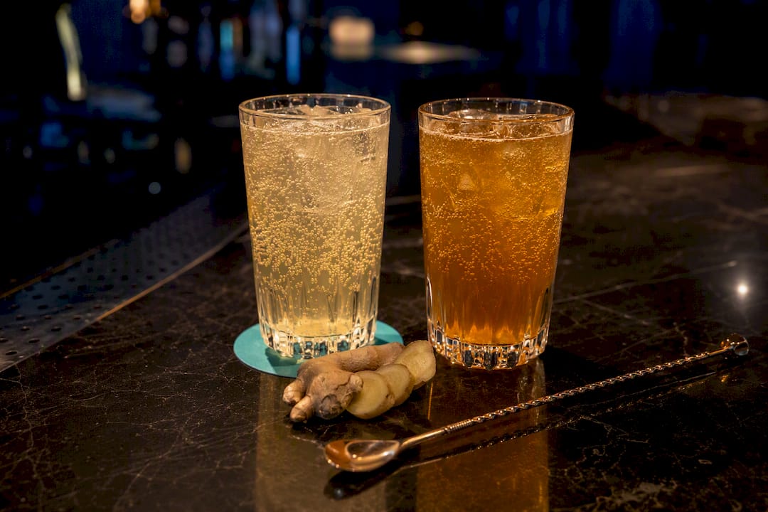 Two glasses comparing ginger ale and ginger beer